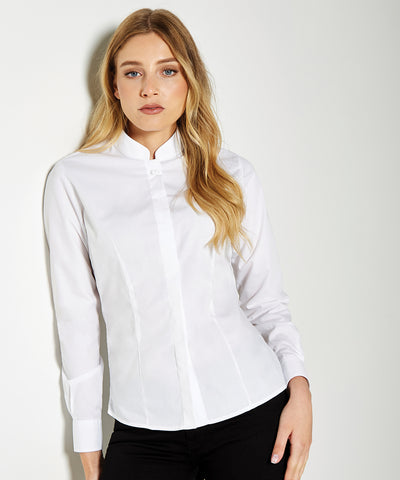 Woman wearing a white blouse against a plain background