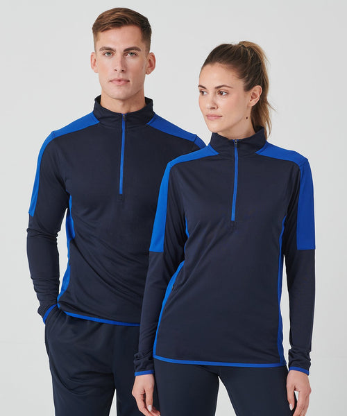 Man and woman wearing matching navy and blue athletic outfits on a white background
