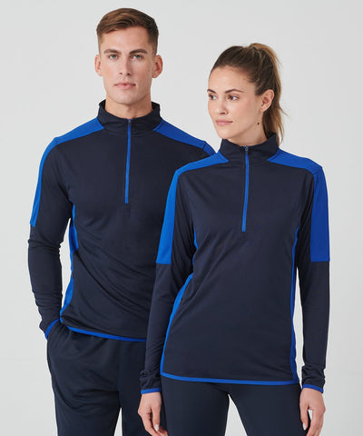 Man and woman wearing matching navy and blue athletic outfits on a white background
