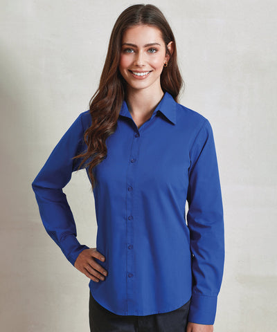 Woman wearing a blue shirt against a plain background