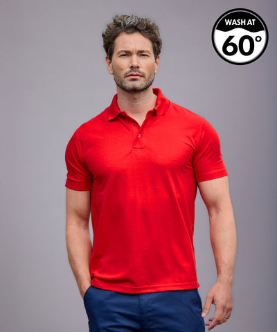 Man wearing a red polo shirt on a gray background with a washing instruction label.