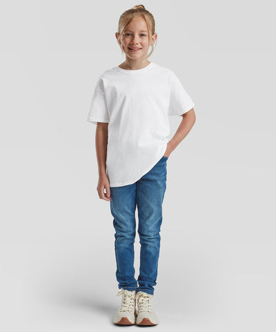 Child wearing a plain white t-shirt and blue jeans on a light gray background